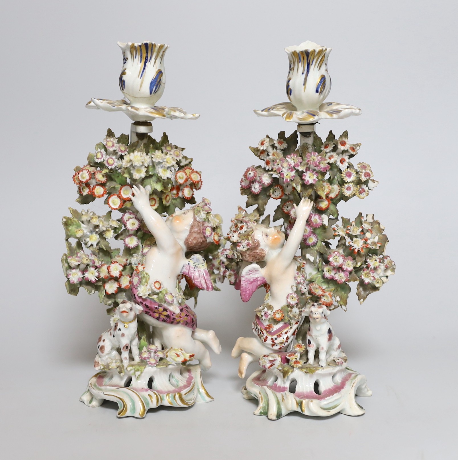 A pair of 18th century Bow putti figural candlesticks, 24cm